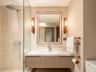 Hospitality guest bathroom with rain shower