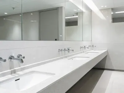 Commercial restroom faucet row